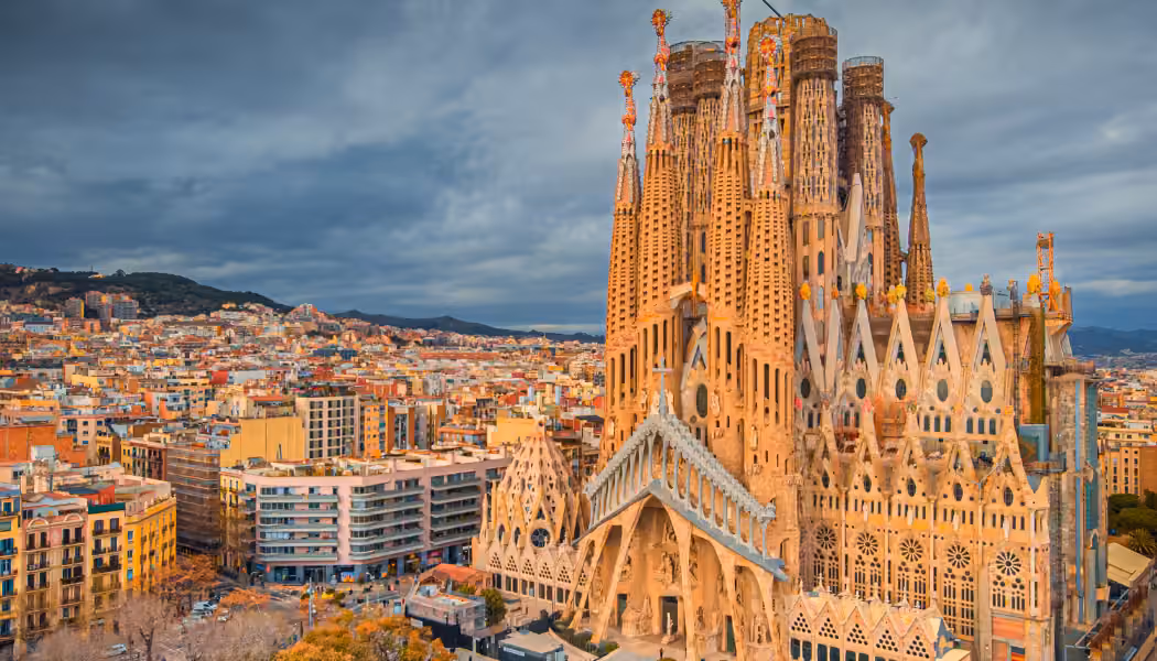A panoramic view of Barcelona's skyline with the beach and Mediterranean sea.